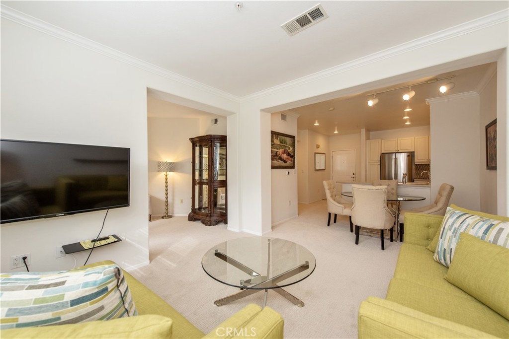 3261 Watermarke Place Irvine, CA 92612 - Photo 5 of 31 a living room with furniture and a flat screen tv