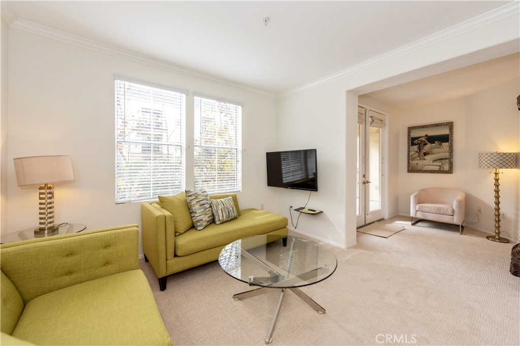 3261 Watermarke Place Irvine, CA 92612 - Photo 7 of 31 a living room with furniture and a flat screen tv