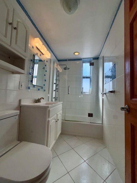 601 79th Street, Unit C20 Brooklyn, NY 11209 - Photo 11 of 13 a bathroom with a toilet sink and shower