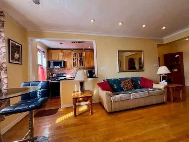 a living room with furniture and kitchen view