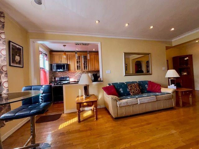 601 79th Street, Unit C20 Brooklyn, NY 11209 - Photo 2 of 13 a living room with furniture and kitchen view