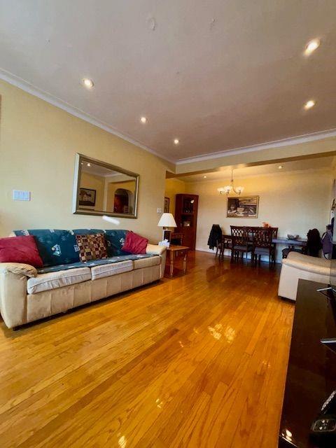 601 79th Street, Unit C20 Brooklyn, NY 11209 - Photo 4 of 13 a living room with furniture and a flat screen tv