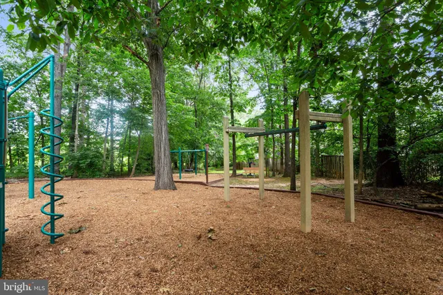 a view of a green field with wooden fence