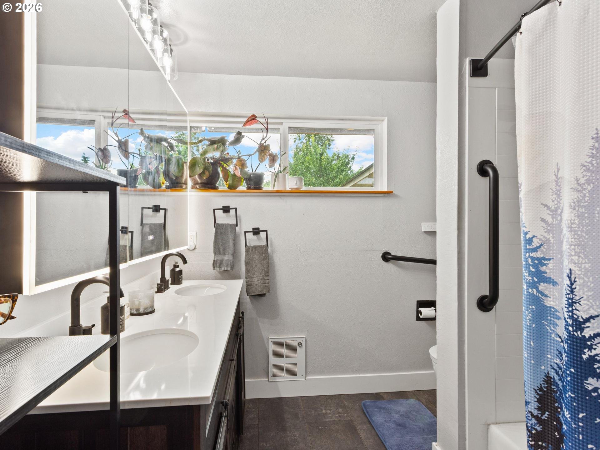 1719 Southwest 1st Street Battle Ground, WA 98604 - Photo 26 of 37 a bathroom with a sink a mirror and a shower