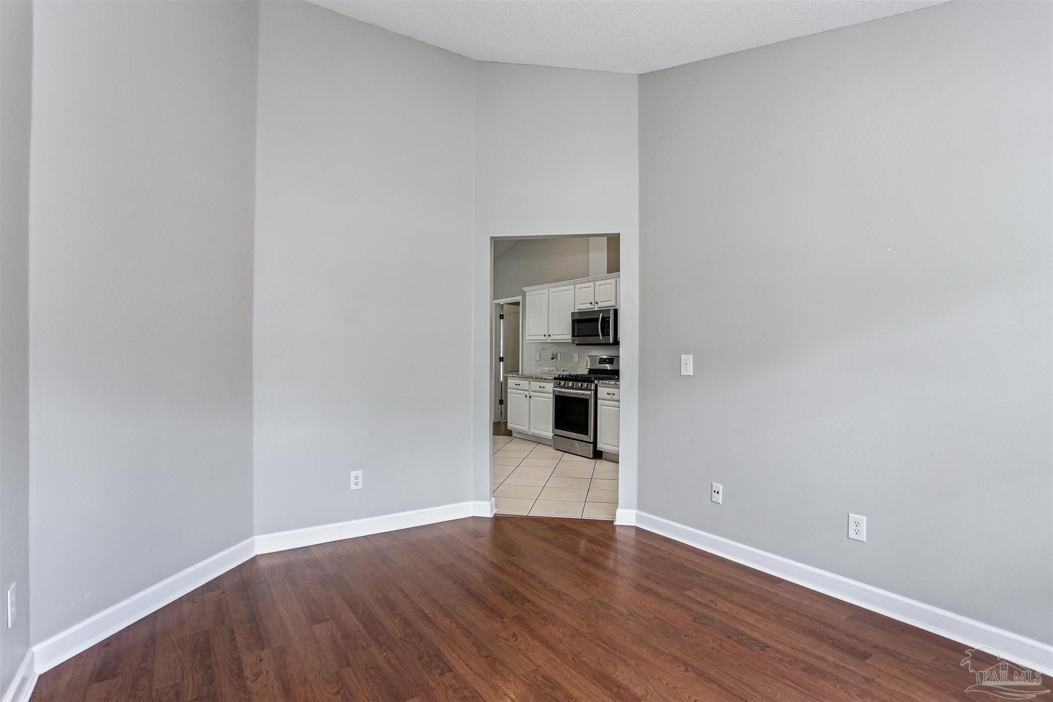 1062 Joaquin Road Pensacola, FL 32506 - Photo 14 of 42 a view of wooden floor and windows in a room