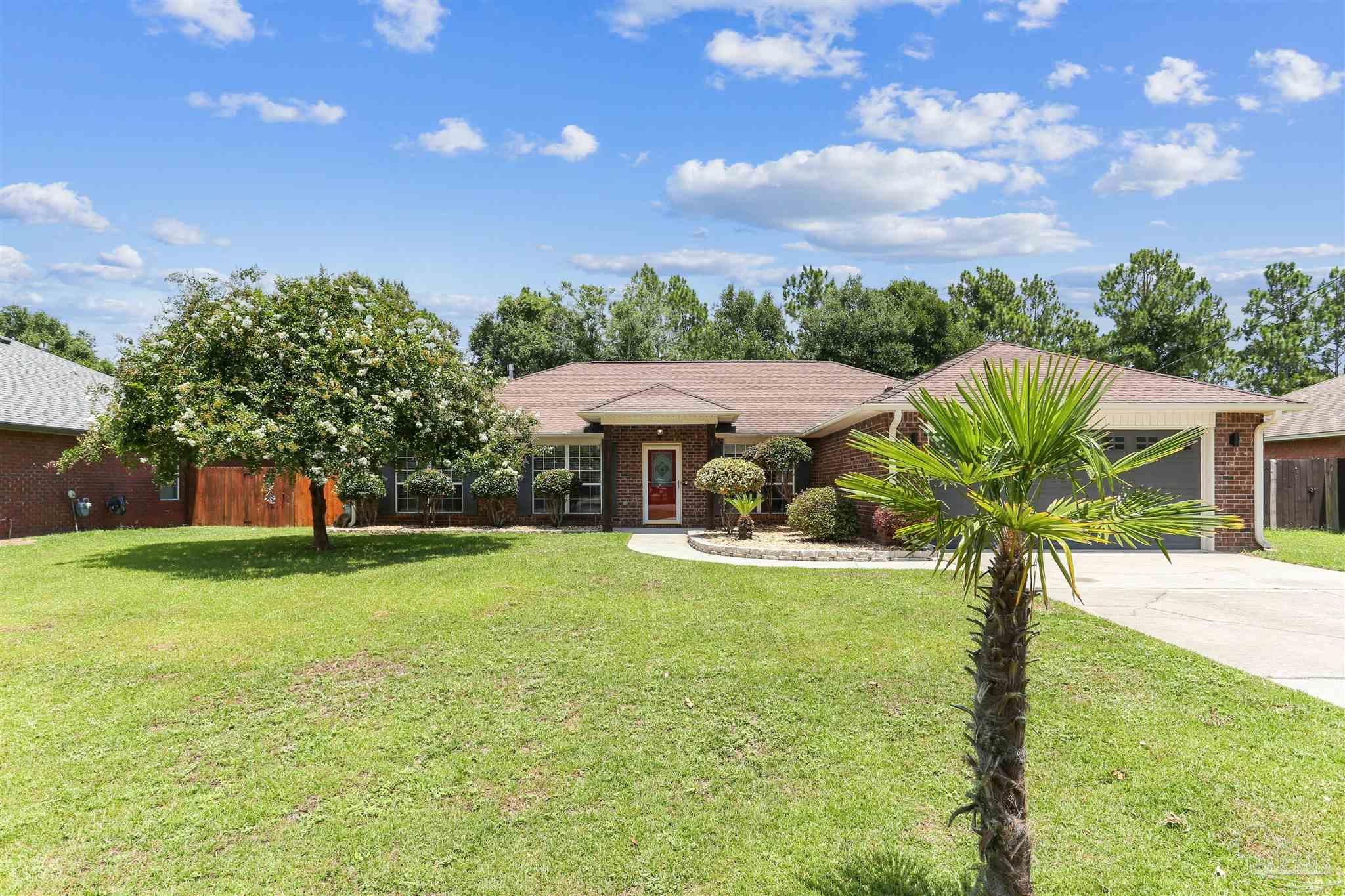 1062 Joaquin Road Pensacola, FL 32506 - Photo 2 of 42 a view of a swimming pool with a table and chairs