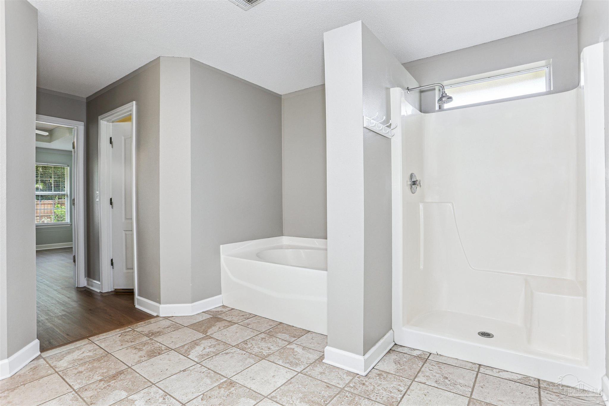 1062 Joaquin Road Pensacola, FL 32506 - Photo 27 of 42 a bathroom with a bathtub and a shower