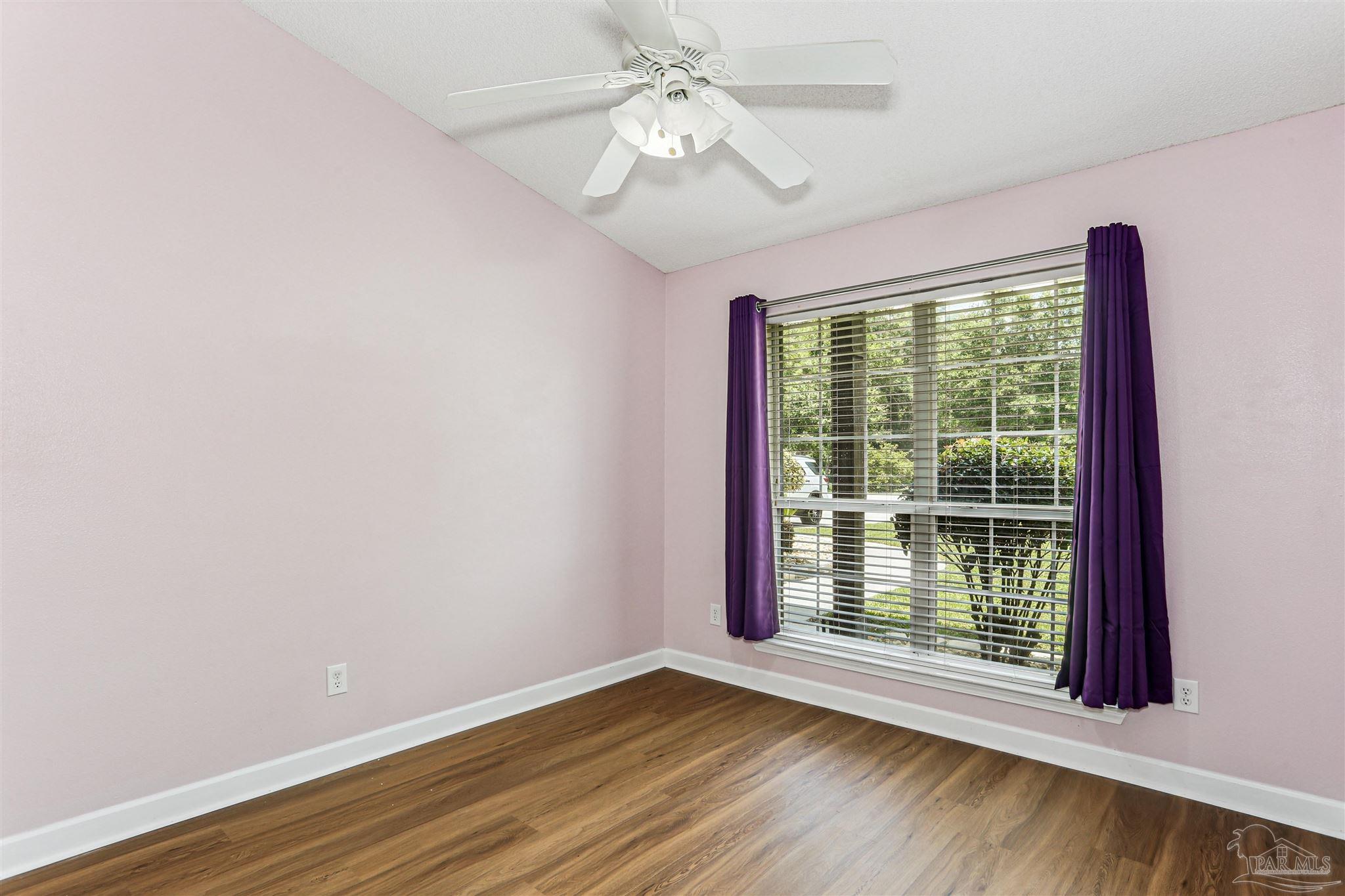 1062 Joaquin Road Pensacola, FL 32506 - Photo 29 of 42 a view of an empty room with wooden floor and a window