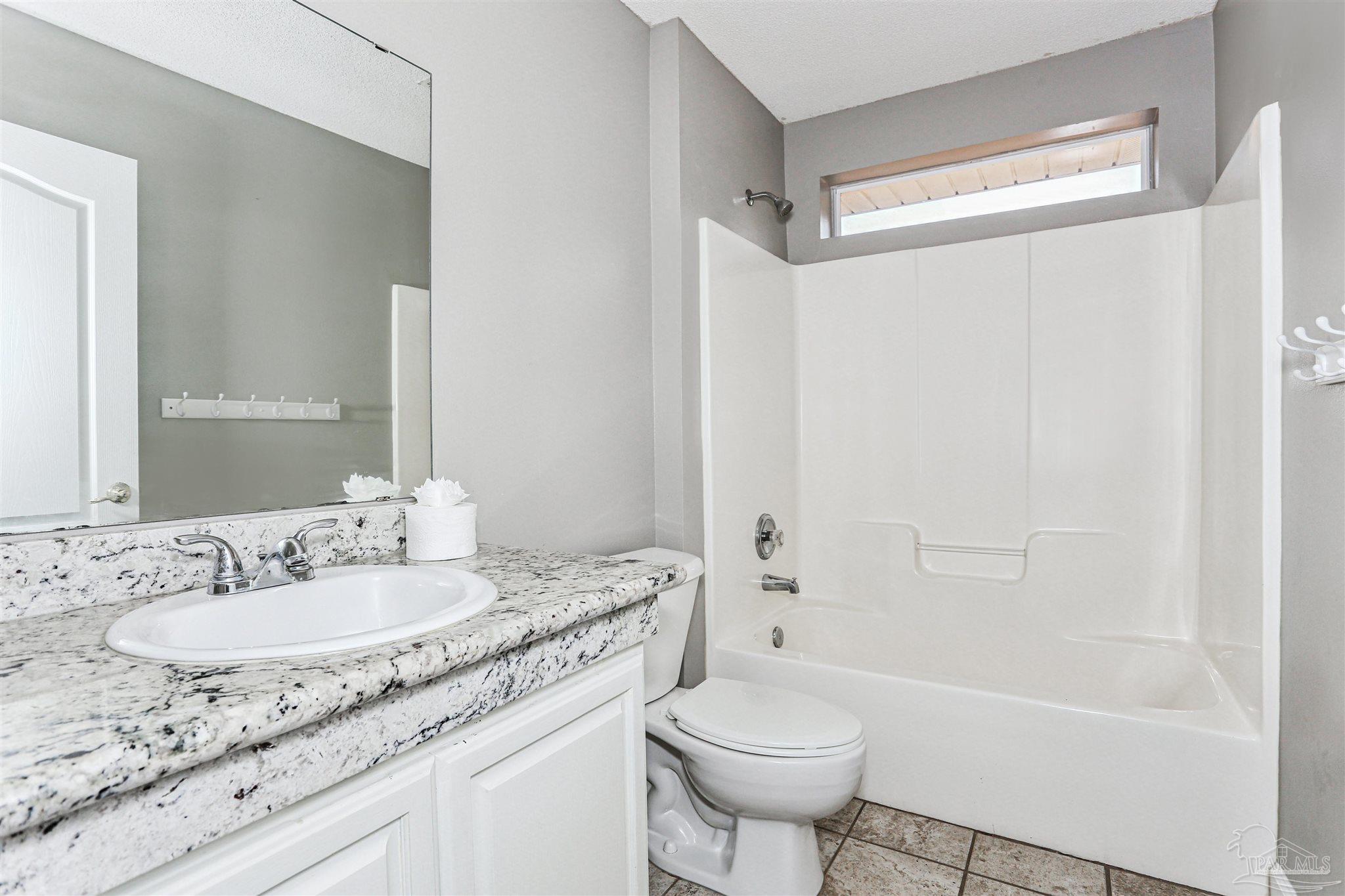 1062 Joaquin Road Pensacola, FL 32506 - Photo 35 of 42 a bathroom with a granite countertop sink toilet and shower