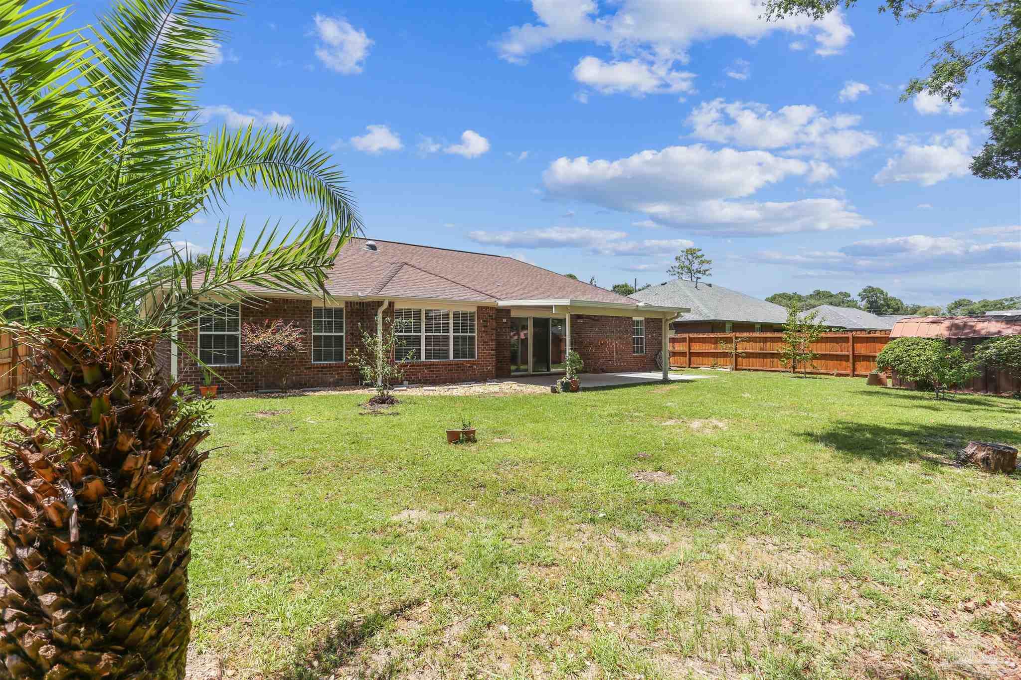 1062 Joaquin Road Pensacola, FL 32506 - Photo 37 of 42 a front view of a house with a yard