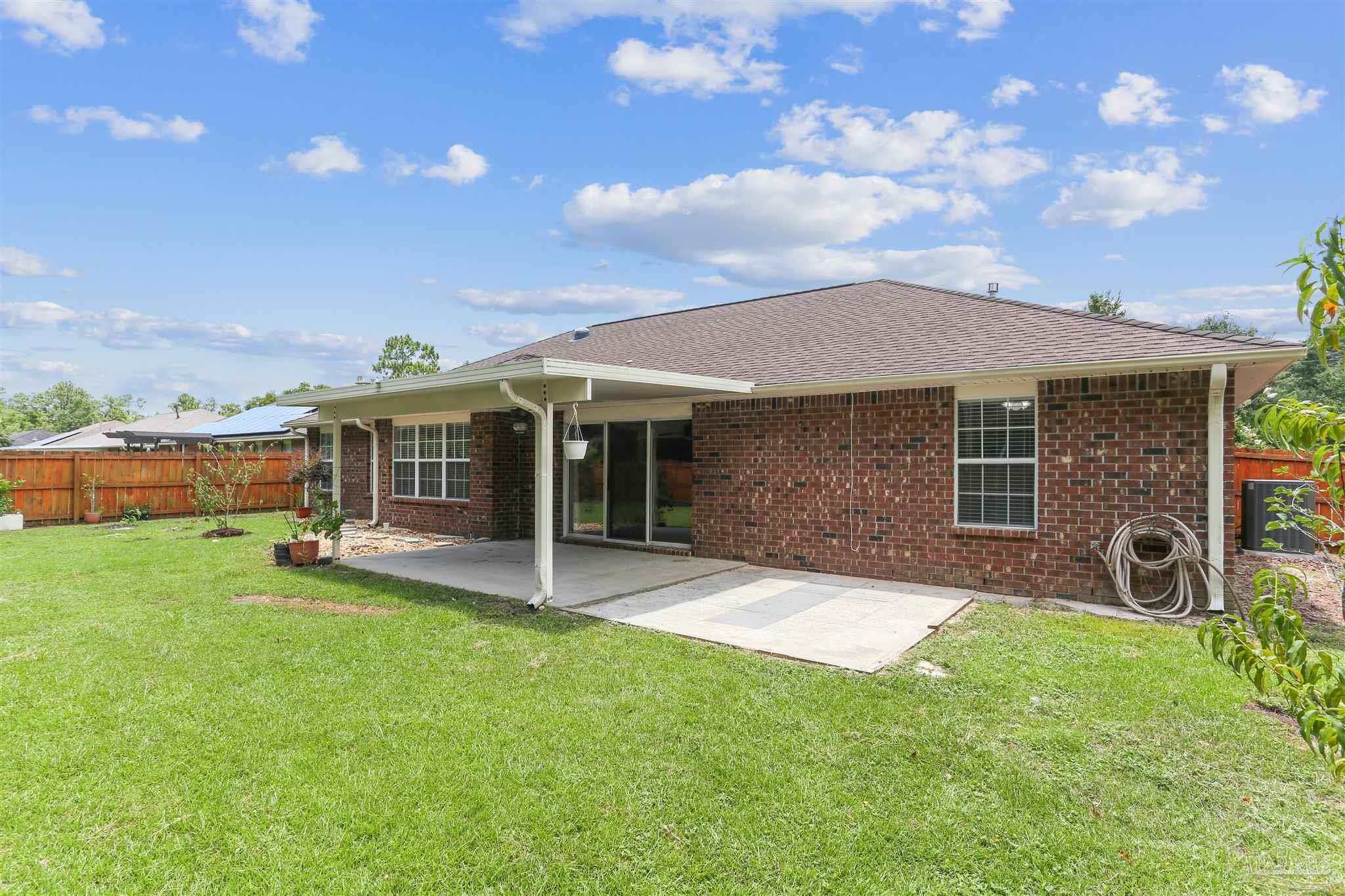 1062 Joaquin Road Pensacola, FL 32506 - Photo 39 of 42 a view of a house with a yard and sitting area