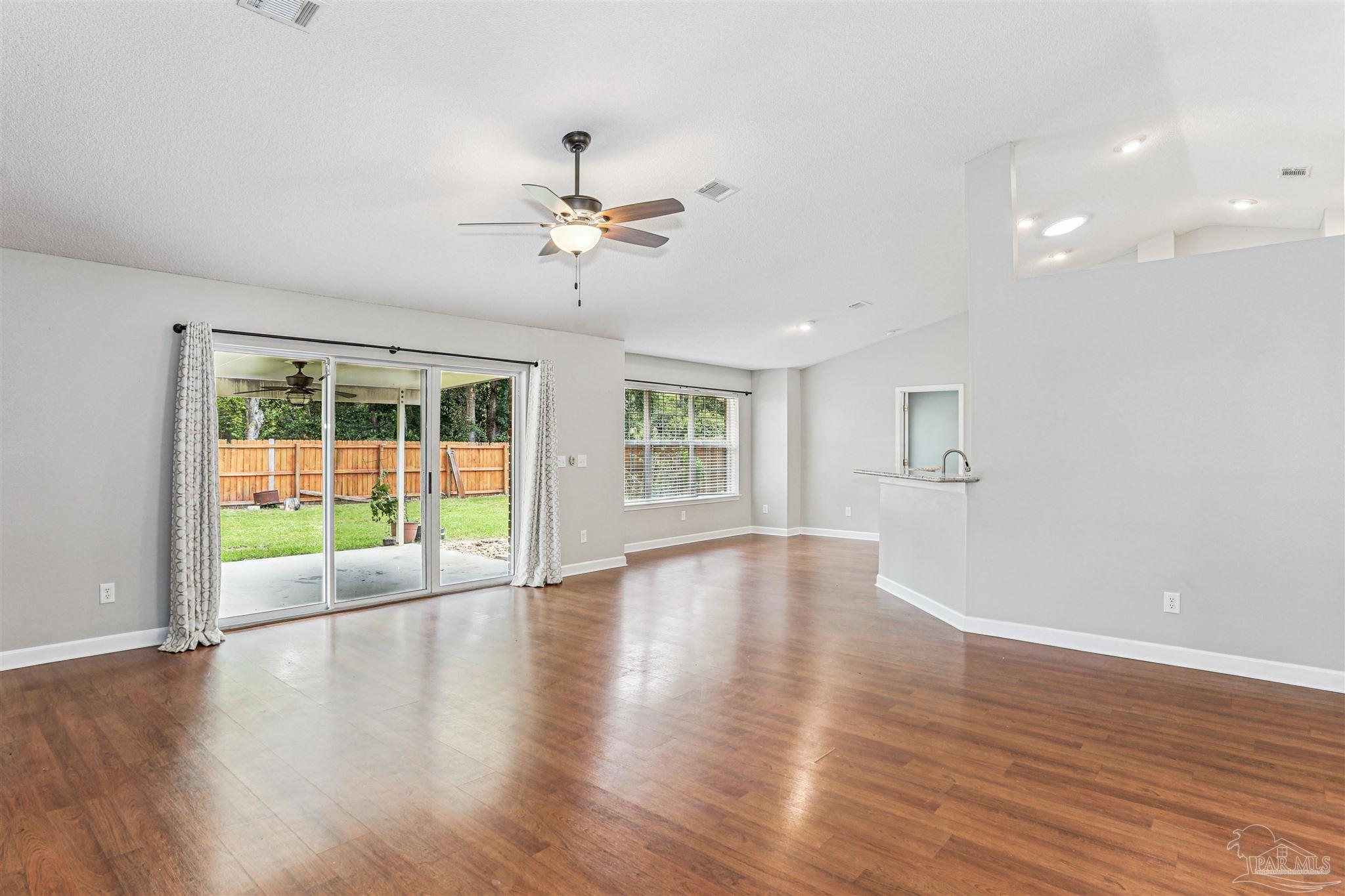 1062 Joaquin Road Pensacola, FL 32506 - Photo 8 of 42 a view of an empty room with wooden floor and a window