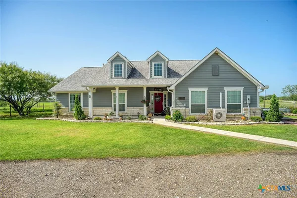 a front view of a house with a yard table and chairs