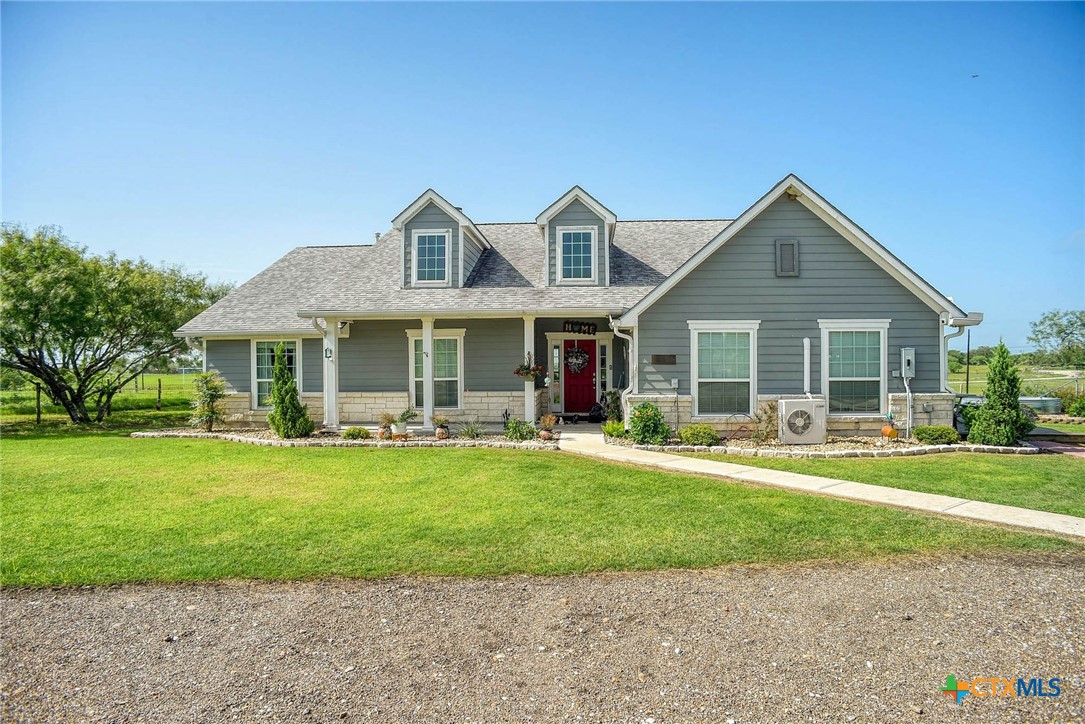 a front view of a house with a yard table and chairs