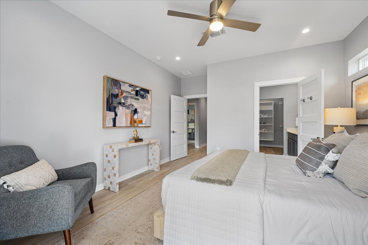 1149 Ebert Avenue, Unit D Austin, TX 78721 - Photo 13 of 34 Bedroom featuring light wood finished floors, recessed lighting, a ceiling fan, and ensuite bath