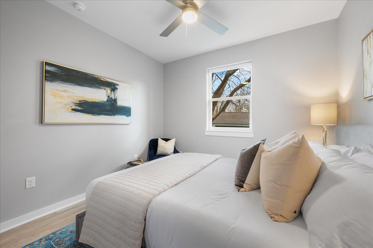 1149 Ebert Avenue, Unit D Austin, TX 78721 - Photo 24 of 34 Bedroom featuring light wood-style flooring and a ceiling fan