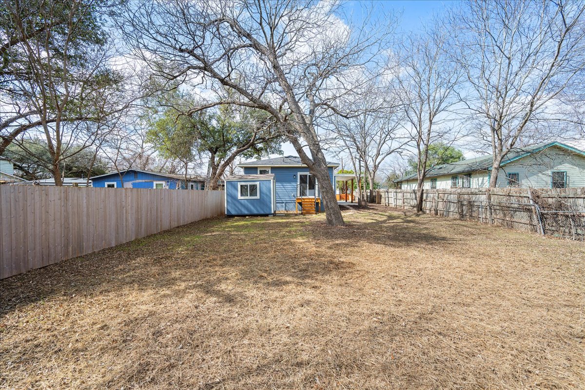 1149 Ebert Avenue, Unit D Austin, TX 78721 - Photo 29 of 34 Fenced backyard featuring an outdoor structure