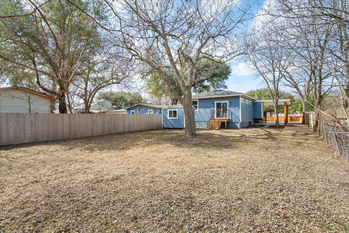 1149 Ebert Avenue, Unit D Austin, TX 78721 - Photo 30 of 34 Rear view of property featuring a fenced backyard