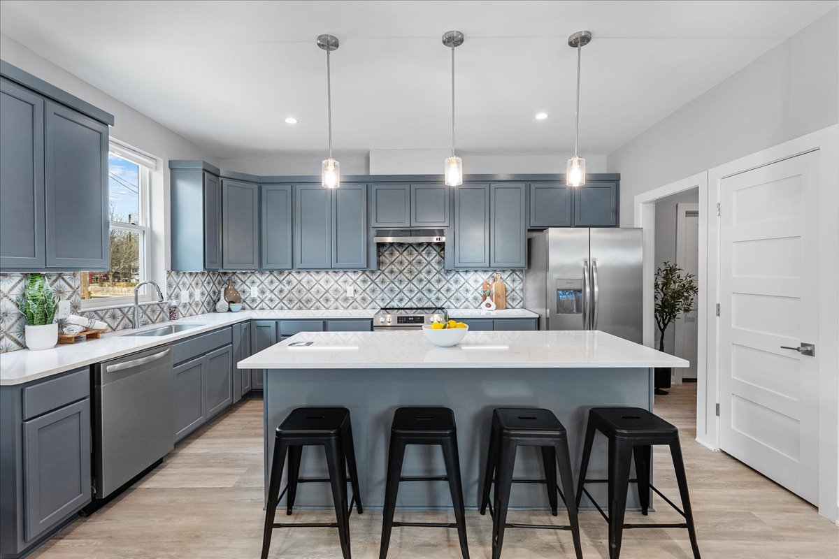 1149 Ebert Avenue, Unit D Austin, TX 78721 - Photo 8 of 34 Kitchen with decorative light fixtures, stainless steel appliances, a breakfast bar, and a center island