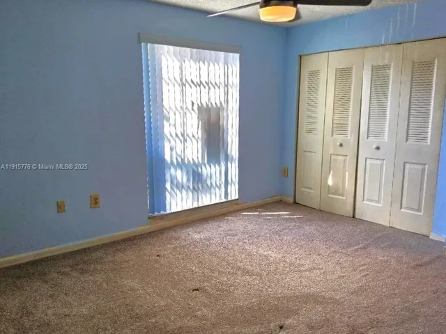 an empty room with windows and yard