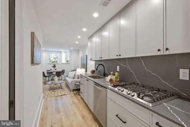 a kitchen with a stove and white cabinets
