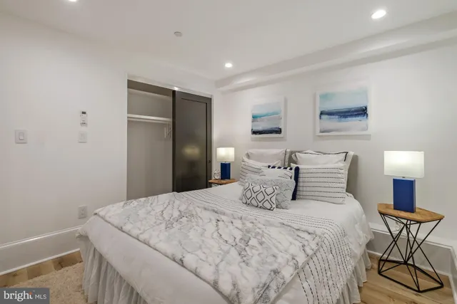 a bedroom with a bed and a lamp