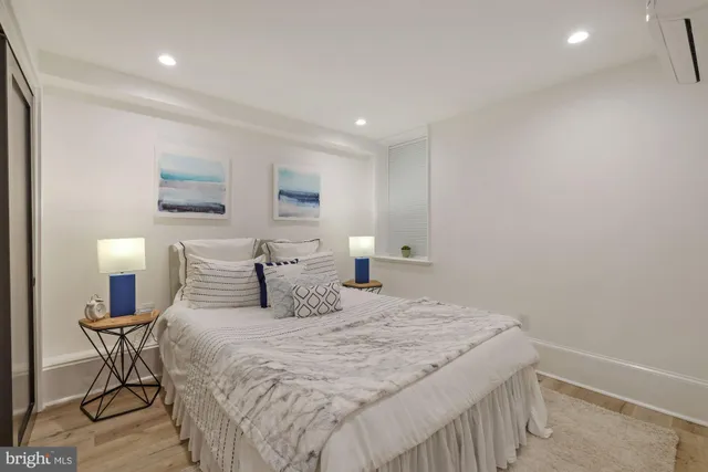 a bedroom with a bed and a chair