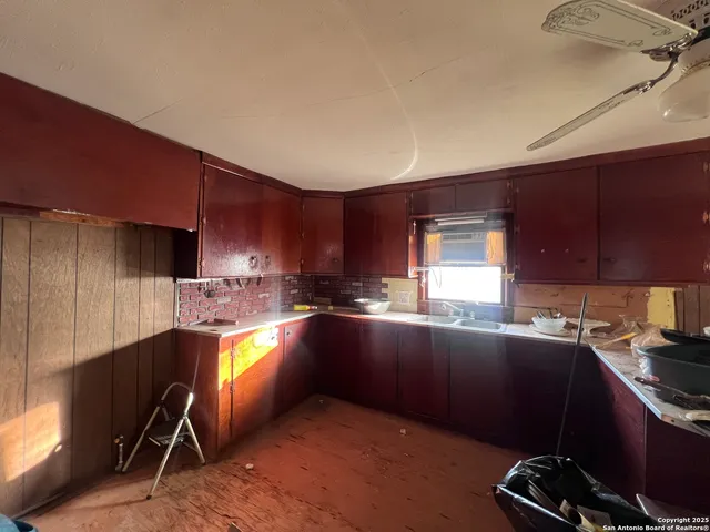 a kitchen with stainless steel appliances wooden cabinets a sink and a stove