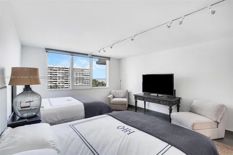 a bedroom with two beds and a couch