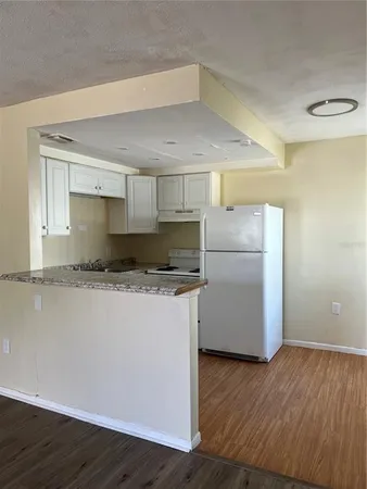 a kitchen with a refrigerator and a sink