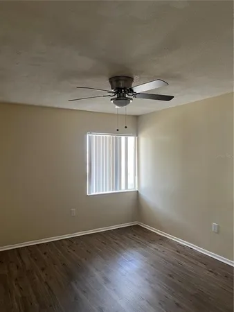 wooden floor that has windows in an empty room