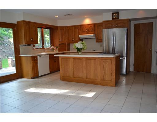 58 Arch Street Riverside, CT 06878 - Photo 3 of 13 a kitchen with stainless steel appliances granite countertop a refrigerator and a sink