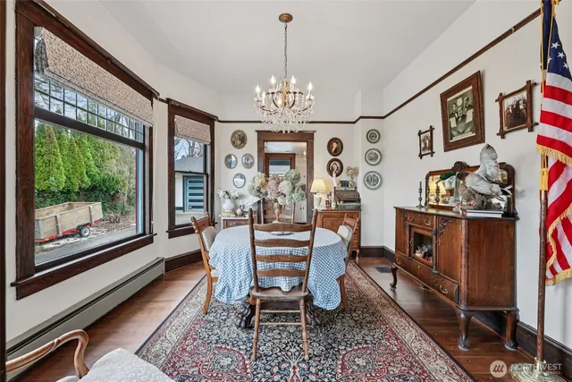 a view of a dining room with furniture a rug and wooden floor