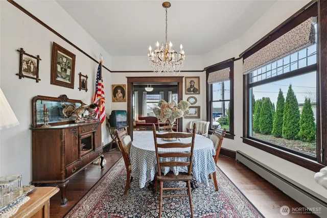 a view of a dining room with furniture a chandelier and window