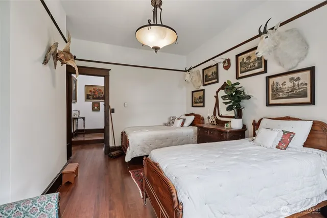 a bedroom with double bed and a wooden floor