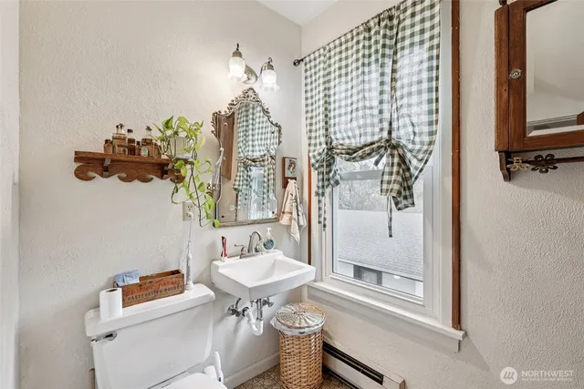 a bathroom with a sink mirror and toilet