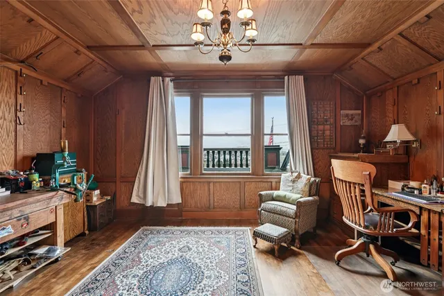 a living room with furniture gym equipment and a window