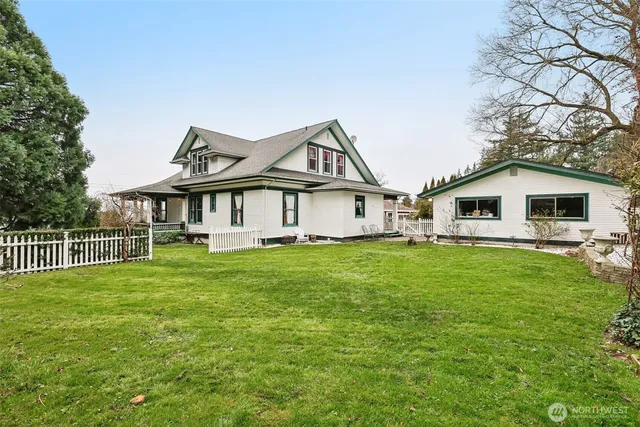 a view of a house with a yard and sitting area