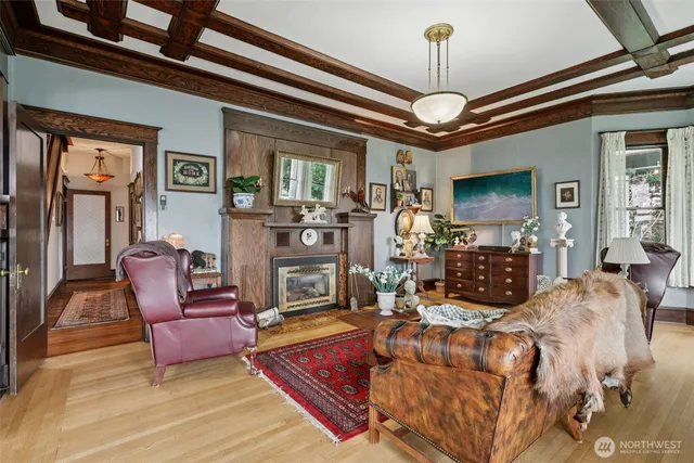 a living room with furniture a chandelier and a flat screen tv