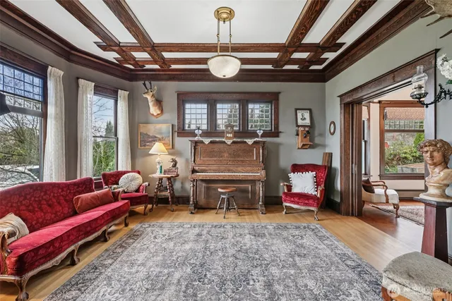 a living room with furniture a flat screen tv and a large window