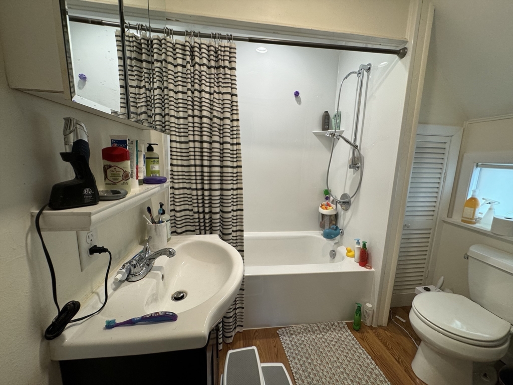 41 Alpine Street Somerville, MA 02144 - Photo 15 of 25 a bathroom with a sink a toilet and shower