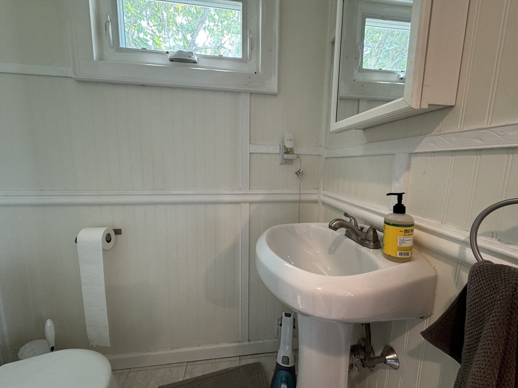 41 Alpine Street Somerville, MA 02144 - Photo 16 of 25 a bathroom with a sink a toilet and a mirror