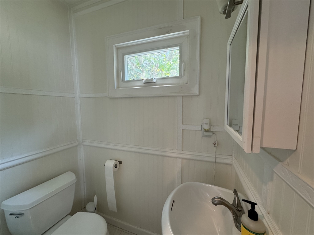 41 Alpine Street Somerville, MA 02144 - Photo 17 of 25 a bathroom with a toilet sink and mirror