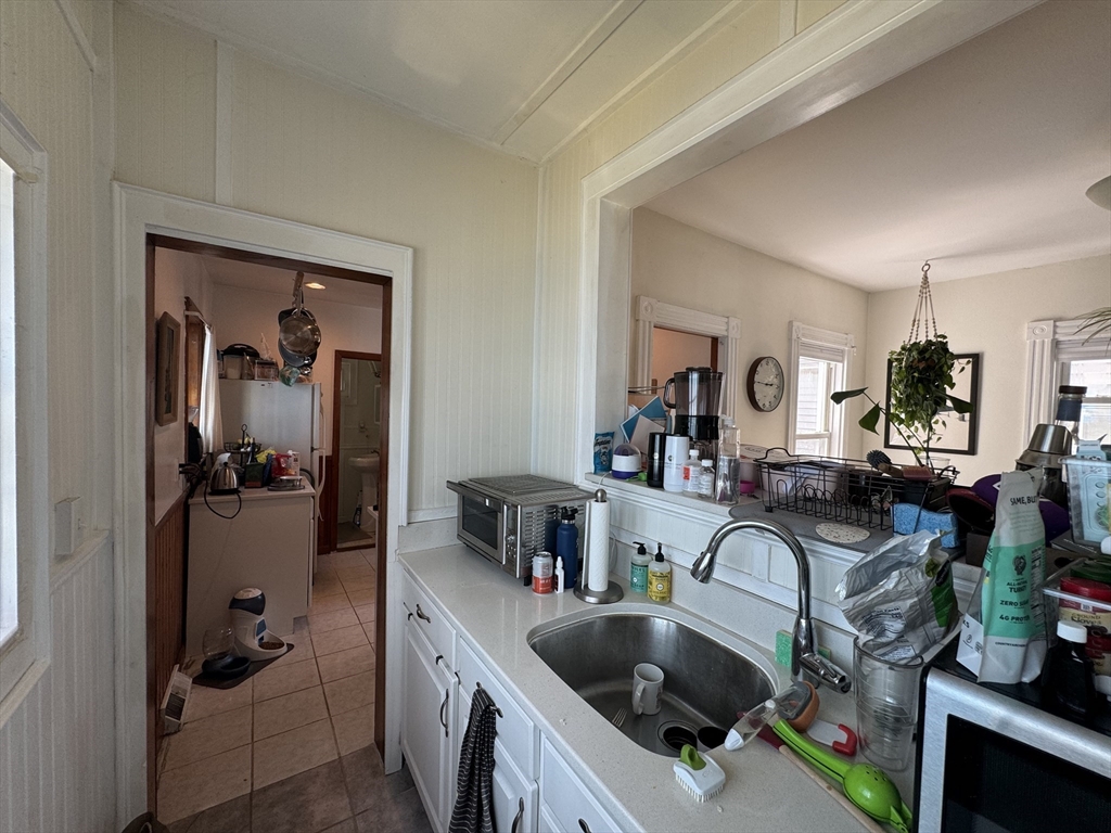 41 Alpine Street Somerville, MA 02144 - Photo 20 of 25 a kitchen with sink refrigerator and cabinets