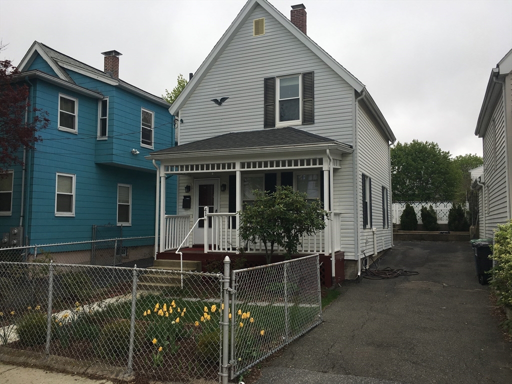 41 Alpine Street Somerville, MA 02144 - Photo 2 of 25 a front view of a house with glass windows and a yard