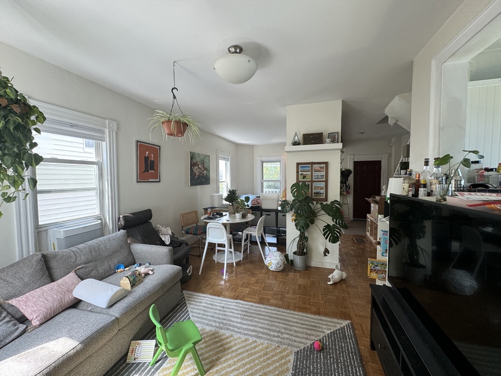 41 Alpine Street Somerville, MA 02144 - Photo 24 of 25 a living room with furniture a fireplace and a window