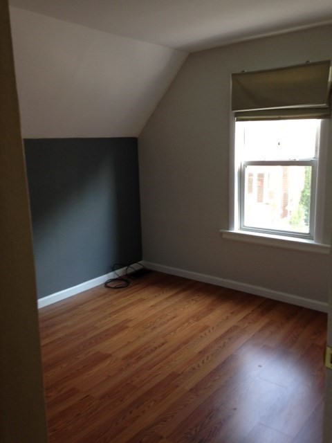 41 Alpine Street Somerville, MA 02144 - Photo 5 of 25 an empty room with wooden floor and windows