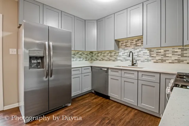 a kitchen with stainless steel appliances granite countertop a refrigerator sink and cabinets