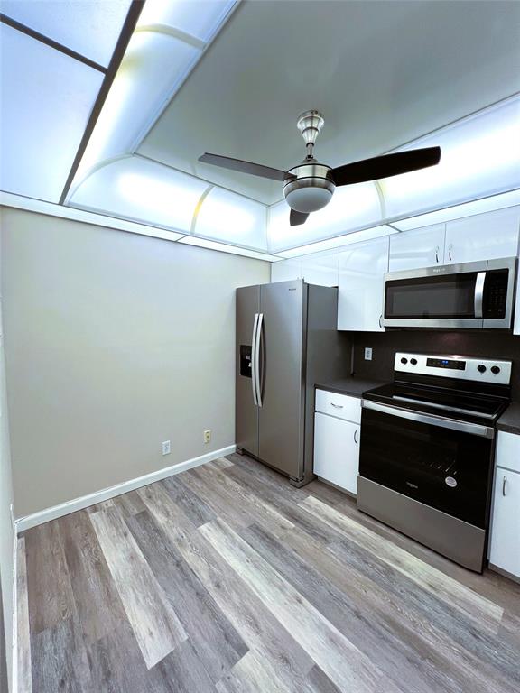 1902 Bermuda Circle, Unit H2 Coconut Creek, FL 33066 - Photo 11 of 32 a kitchen with a refrigerator and a stove