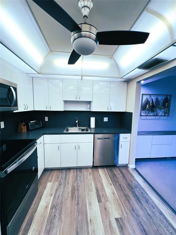 1902 Bermuda Circle, Unit H2 Coconut Creek, FL 33066 - Photo 13 of 32 a large kitchen with stainless steel appliances granite countertop a lot of cabinets a stove and a granite counter top